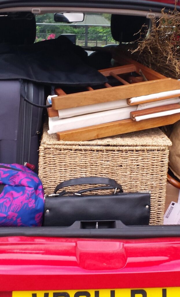 The boot of a red Renault Clio packed with props and set for 2 show of Bard Heads in August 2014