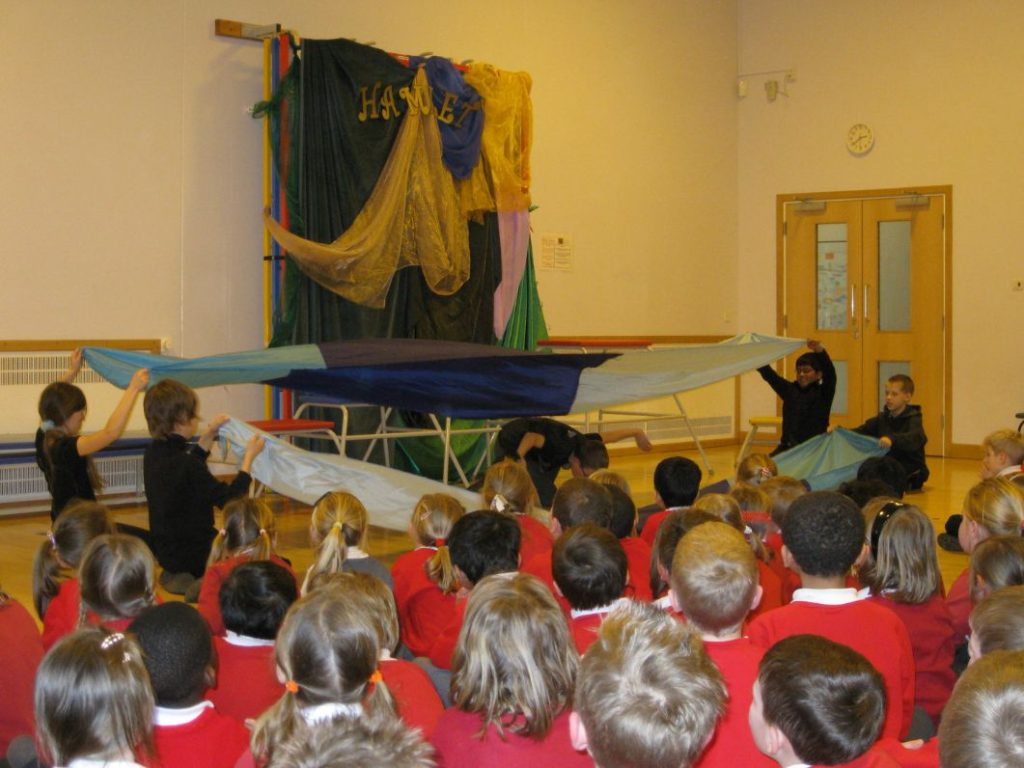 Image shows children at Heritage Park Primary in a Hamlet workshop
